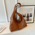Soft PU leather shoulder bag with sewing thread accents and sandwich pocket design