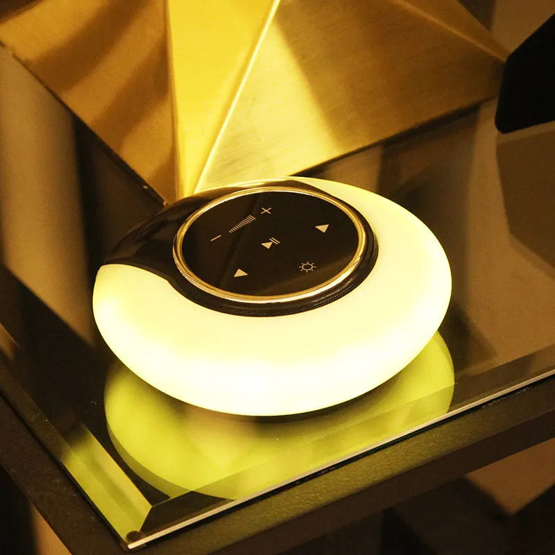 Bluetooth desk lamp with speaker showing folding design, touch controls, and LED lighting in plastic housing