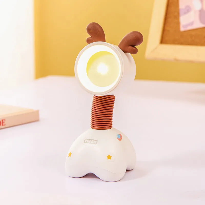 DIY cartoon animal small night lamp with magnetic base in assorted colours on a desk.