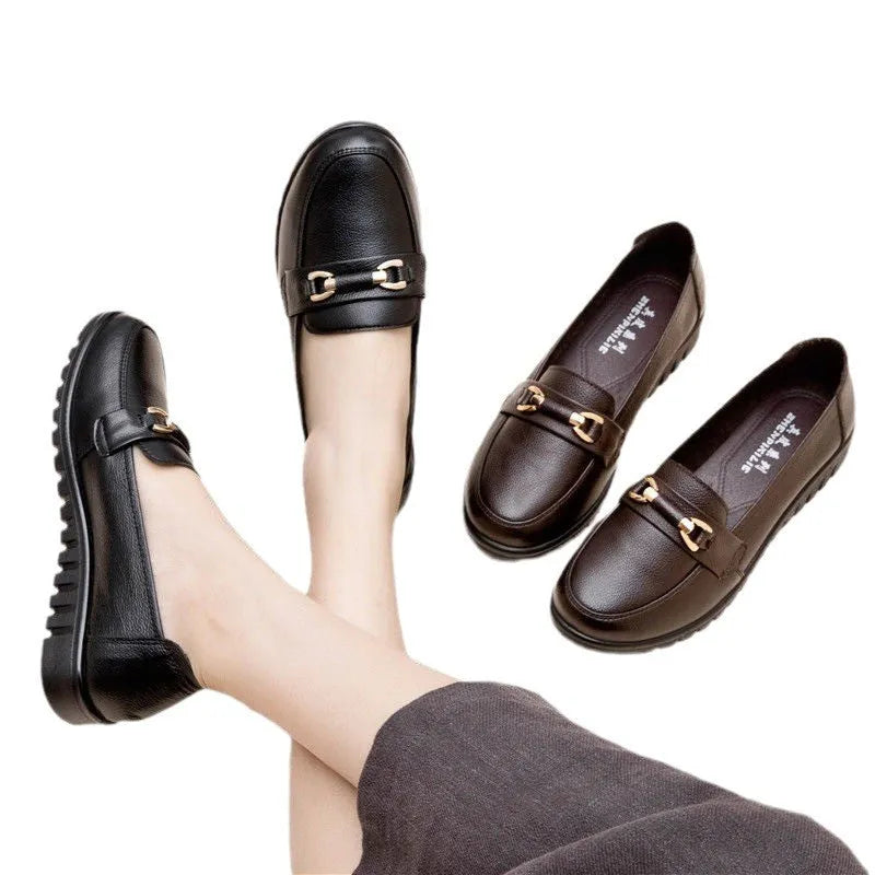 Black soft leather pumps with a round toe, low flat heel, and shallow cut design on a plain background.