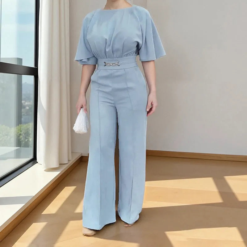 Blue two-piece polyester suit with long sleeves and trousers on a hanger