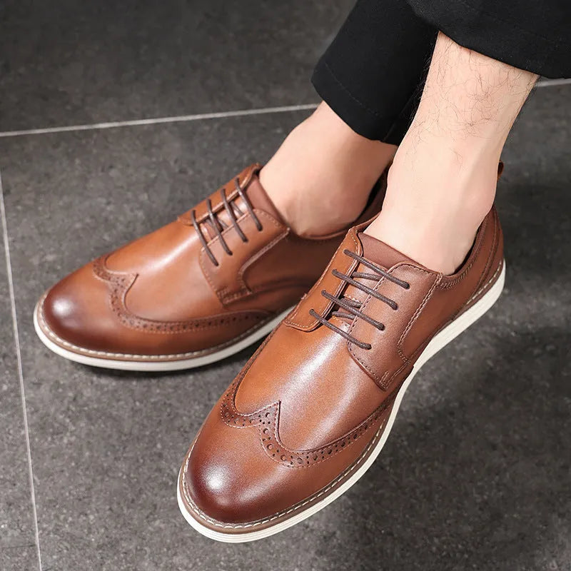 Men's black slip-on business casual shoes with decorative carving details on PU leather upper