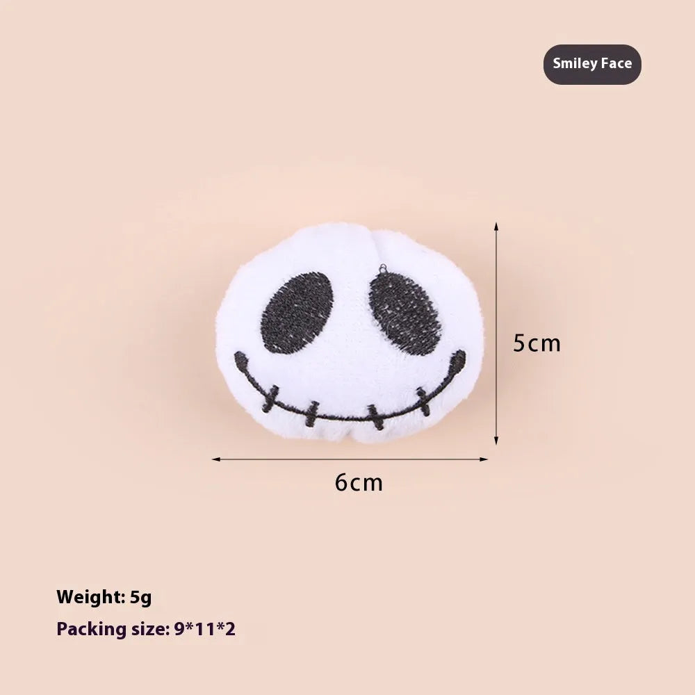 Small cat teaser wand with dangling plush candy, eye, and skull toy attachments