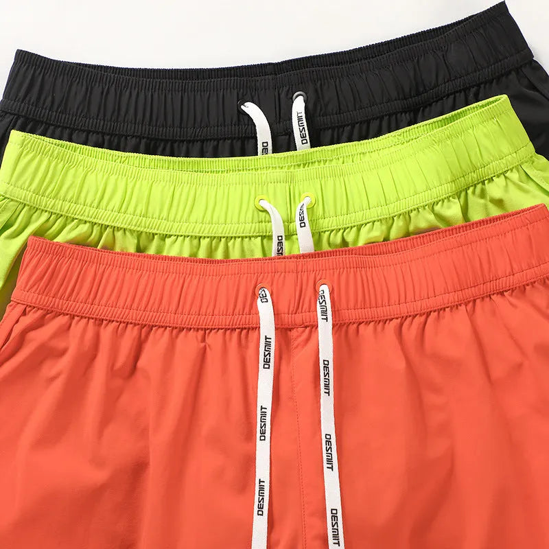 Men's loose fit summer shorts in orange, green, or black for beach and surfing leisure wear