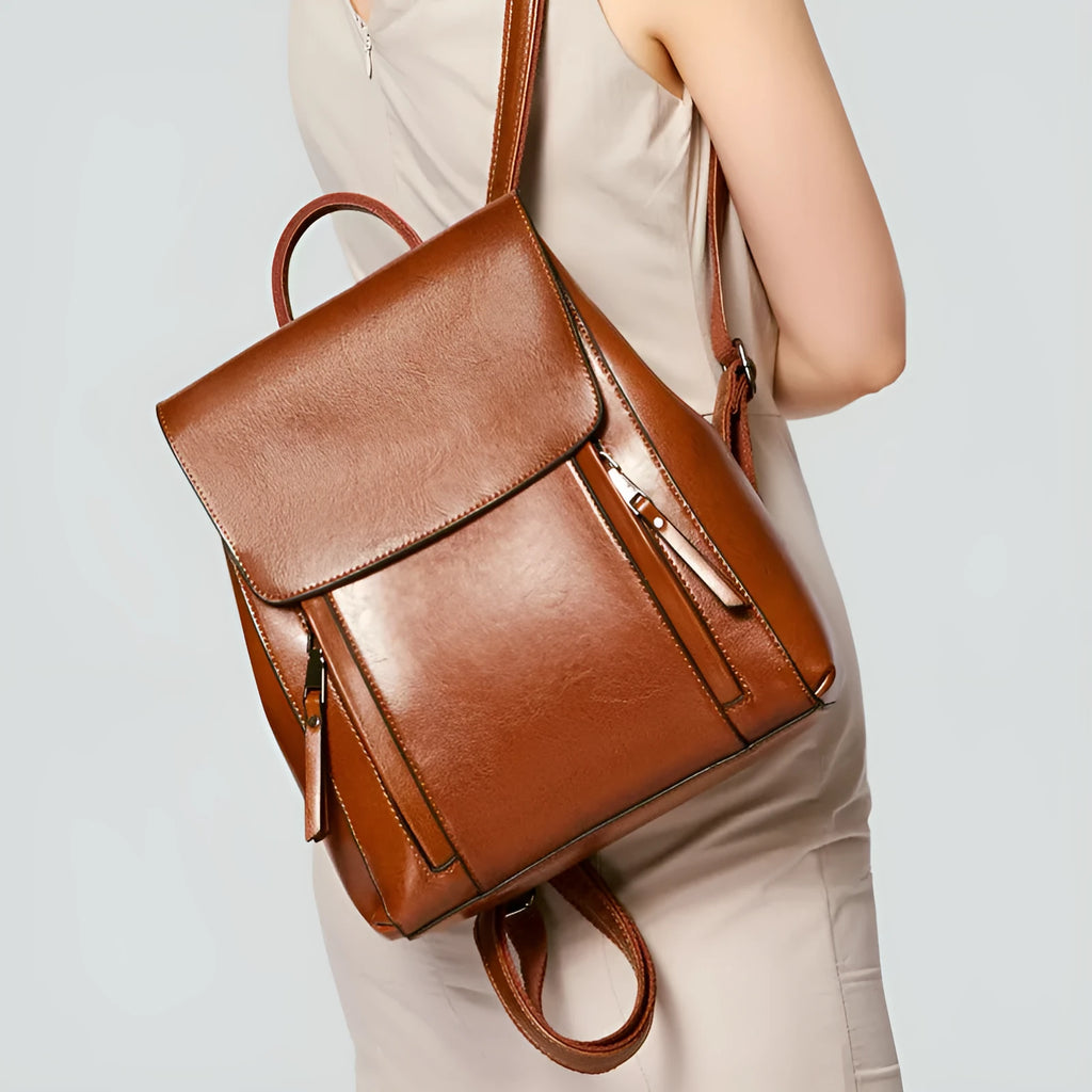 Genuine leather women's backpack in square vertical shape with double straps and stitching detail.