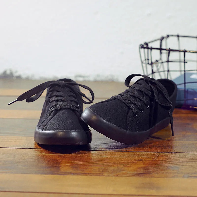 All black Korean style canvas flat work shoes for women with front lace-up and rubber sole