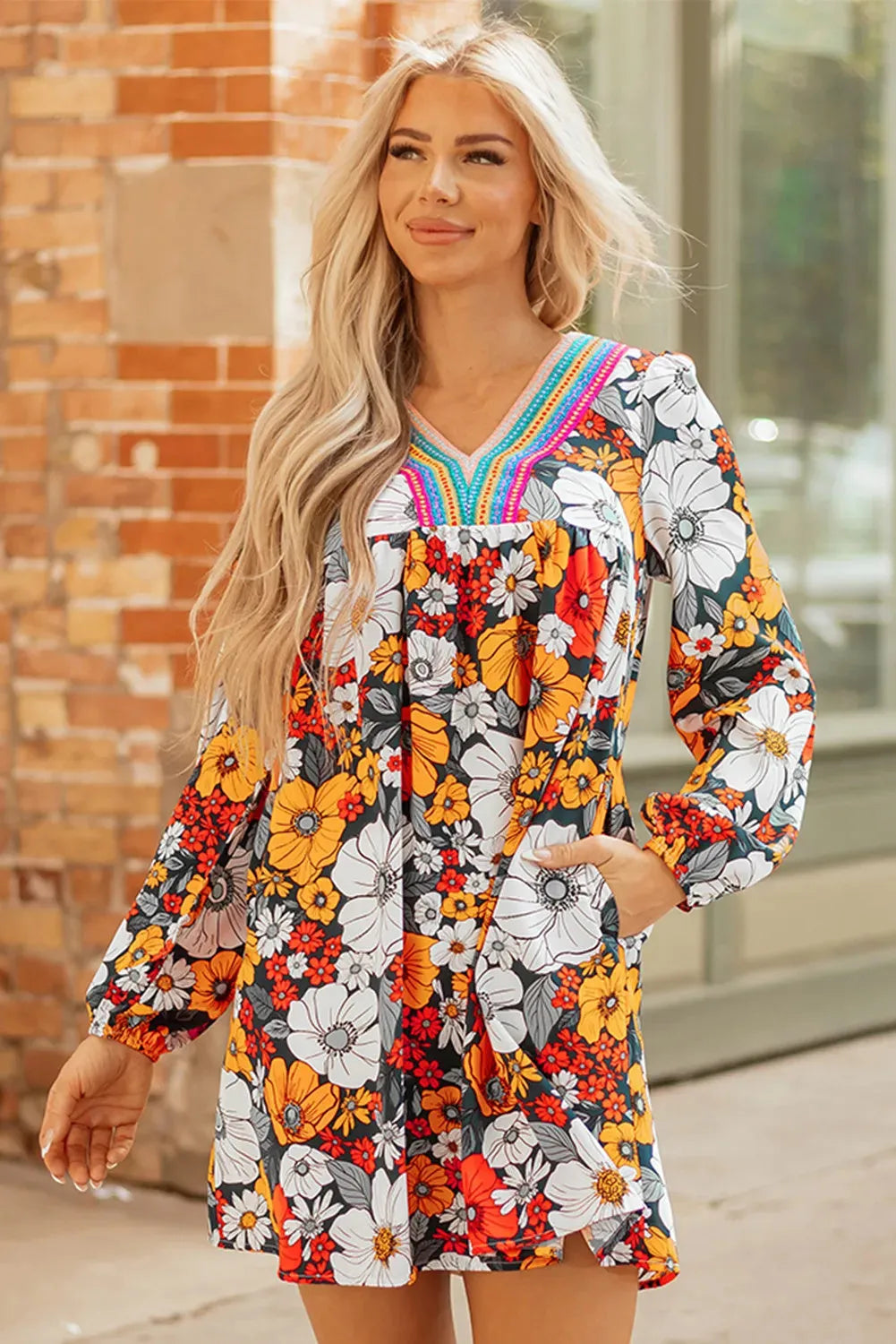 Orange floral print women's mini dress with V neck, long sleeves, and striped lace detail.