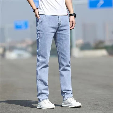 Men's straight-leg smoky gray jeans with low-rise waist and zip fly.