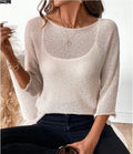 Women's light grey knitted off-shoulder top with a 3D textured pattern on a hanger.