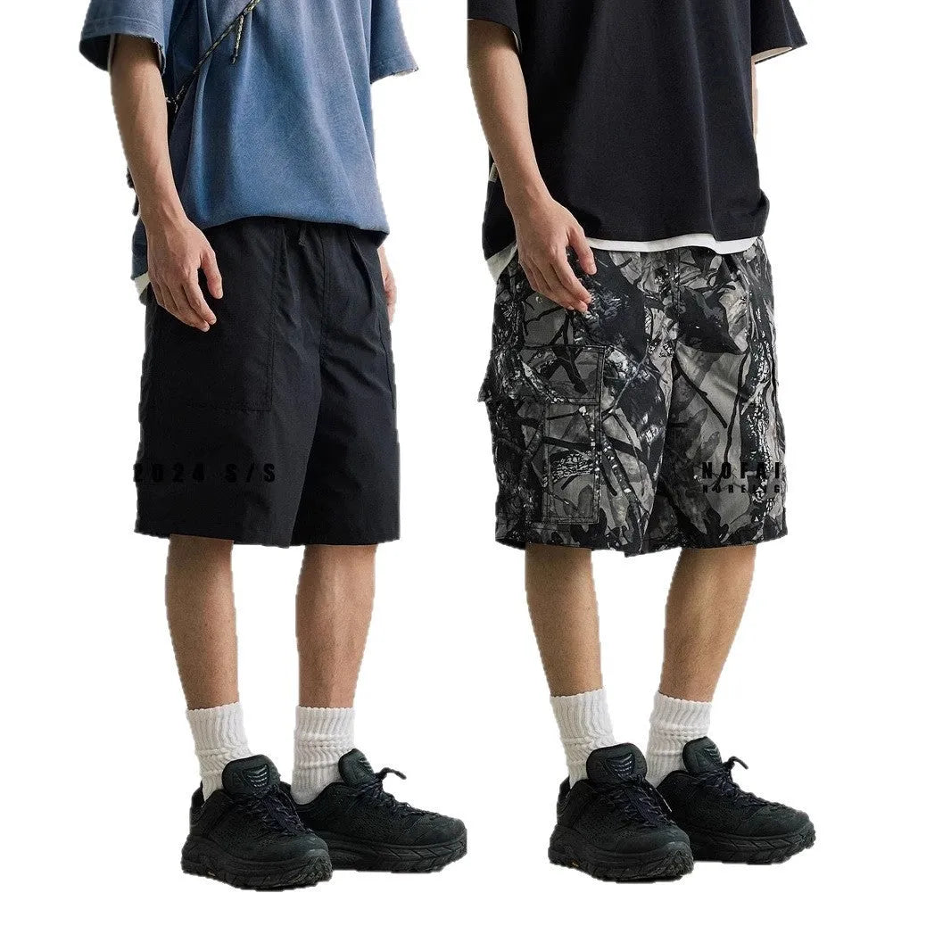 Men's loose fit straight-leg denim shorts in army green colour with a mid waist and zip fly.