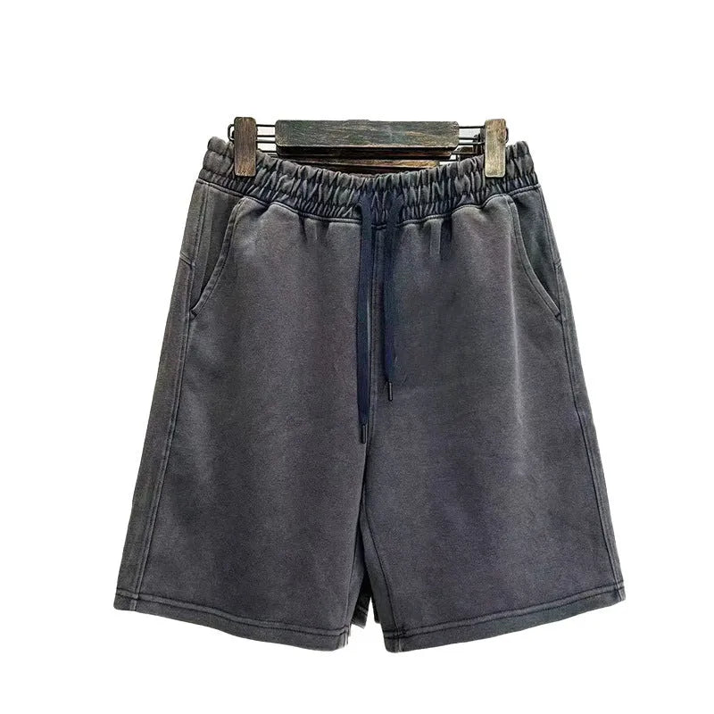 Men's distressed cotton casual shorts in loose straight fit showing fifth length measurement