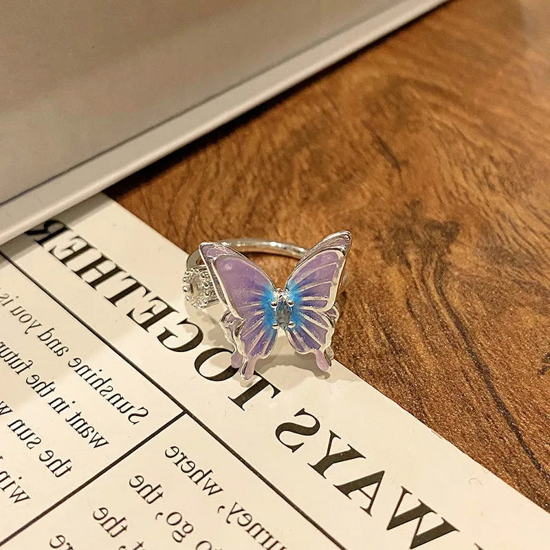 Copper butterfly women's ring with oil-drip finish showing open-loop design