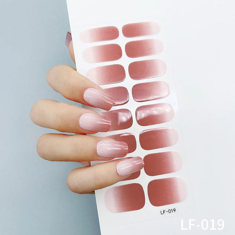 Full sheet of nail art stickers showing sixteen small designs including cross, rose, tulip, and leopard print patterns.