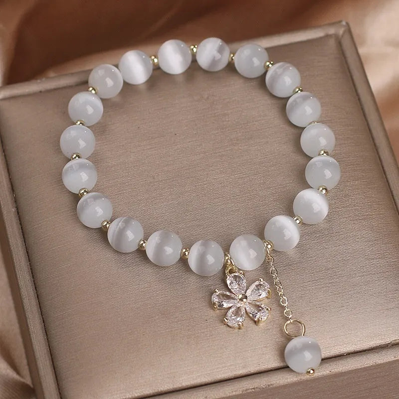 Women's white cat's eye stone bracelet with morganite safety buckle and flower tassel decoration