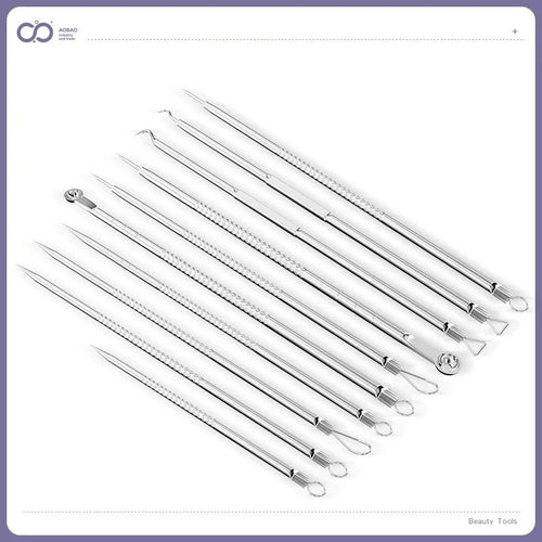 Four silver metal acne needles with fine pointed tips laid out on a flat surface.