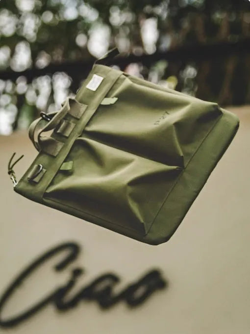 Marden Tooling charcoal black canvas messenger bag with crossbody strap, shown open to reveal laptop compartment.