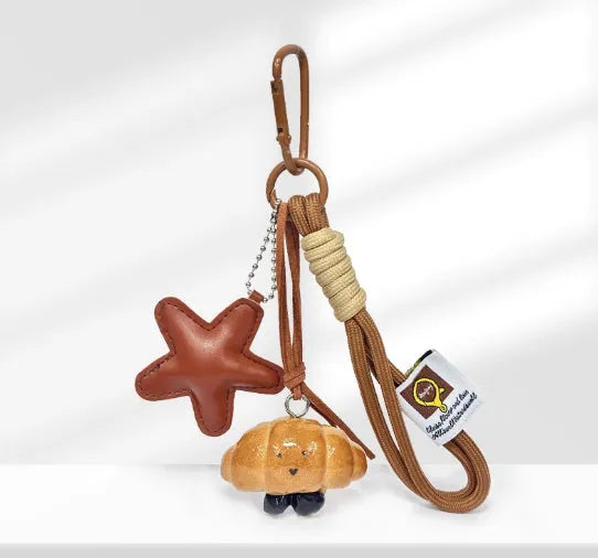 Handmade soda bread handbag pendant with brown star details and carrying strap
