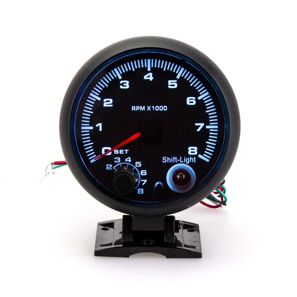 Black automotive tachometer with blue light pointer on a 0-8000 RPM scale
