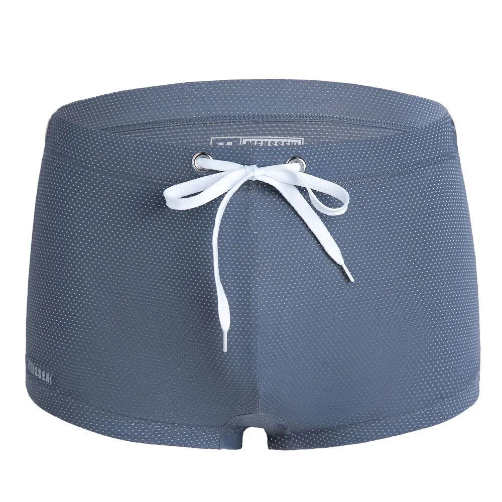 Men's low waist nylon swimming trunks in a solid colour on a white background.