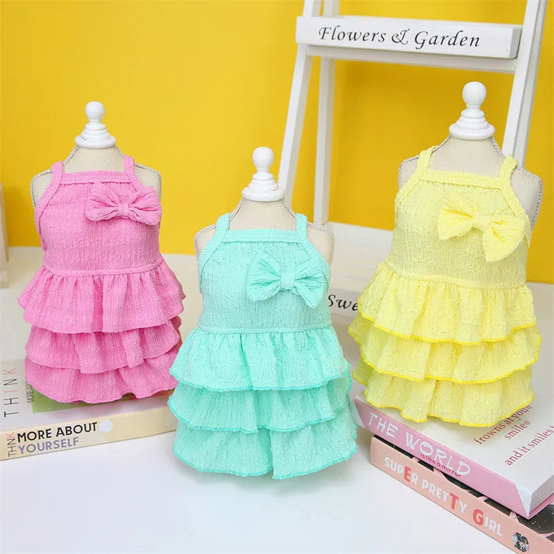 Small dog wearing rose red princess dress with layered skirt candy theme