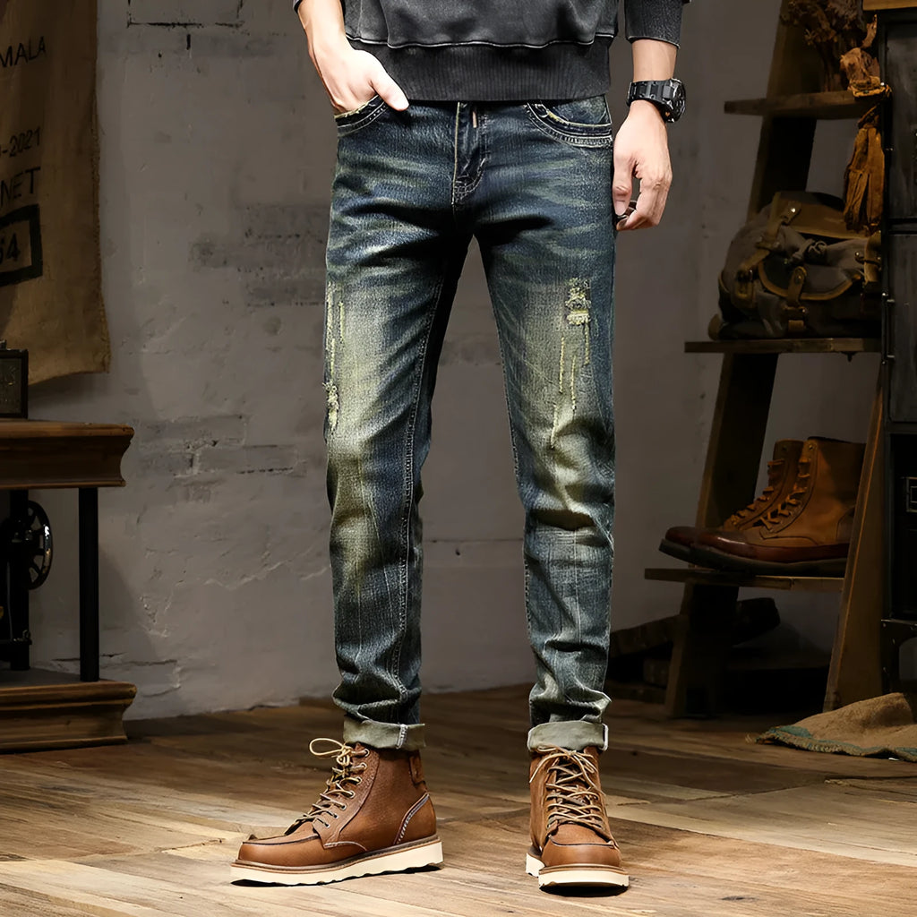 Men's skinny fit retro blue jeans with a zip fly closure laid flat.