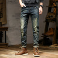 Men's skinny fit retro blue jeans with a zip fly closure laid flat.