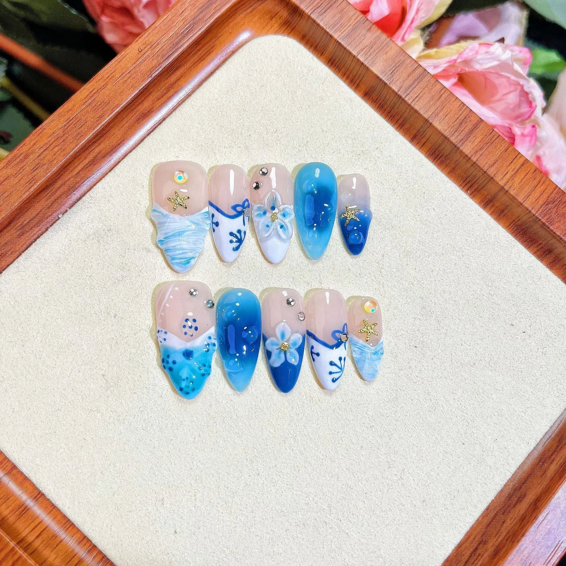 Blue hand-painted carved false nails on transparent summer base with XS, S, M, L size options