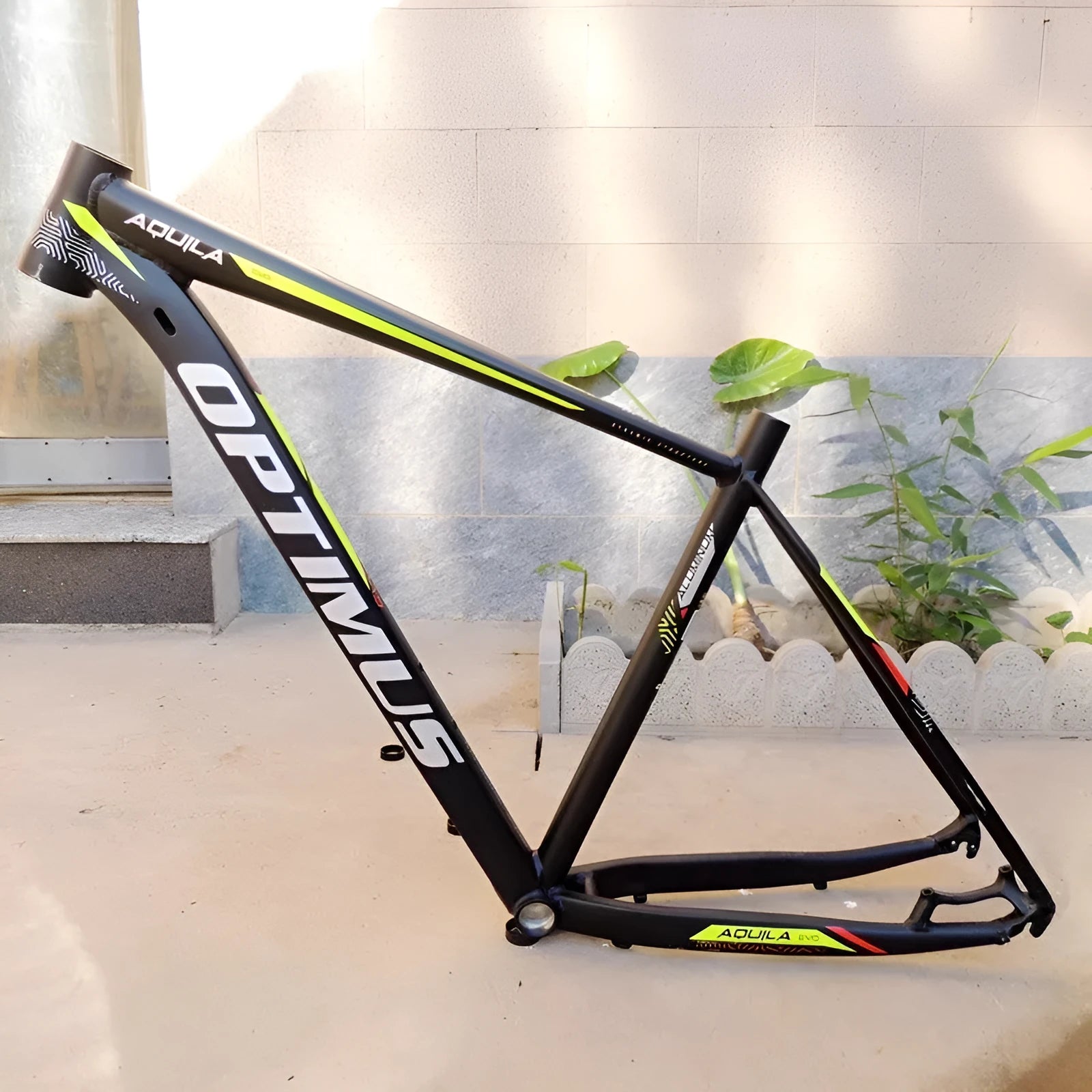 Black green 29-inch aluminium mountain bike frame showing internal cable ports and disc brake mounts