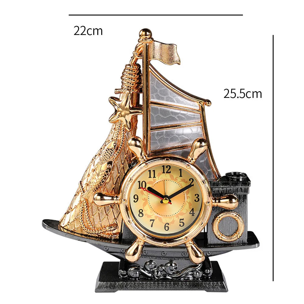 Modern metallic-finish bedroom alarm clock in gold or silver on a bedside table.