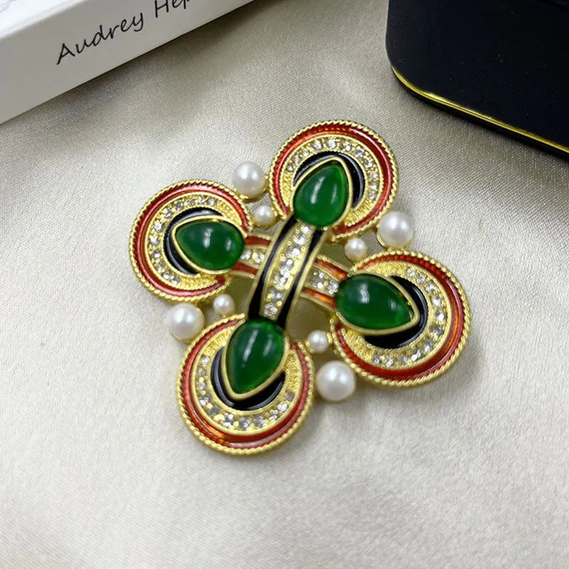 Close-up of a vintage medieval baroque cross brooch with crystals, made from zinc alloy.