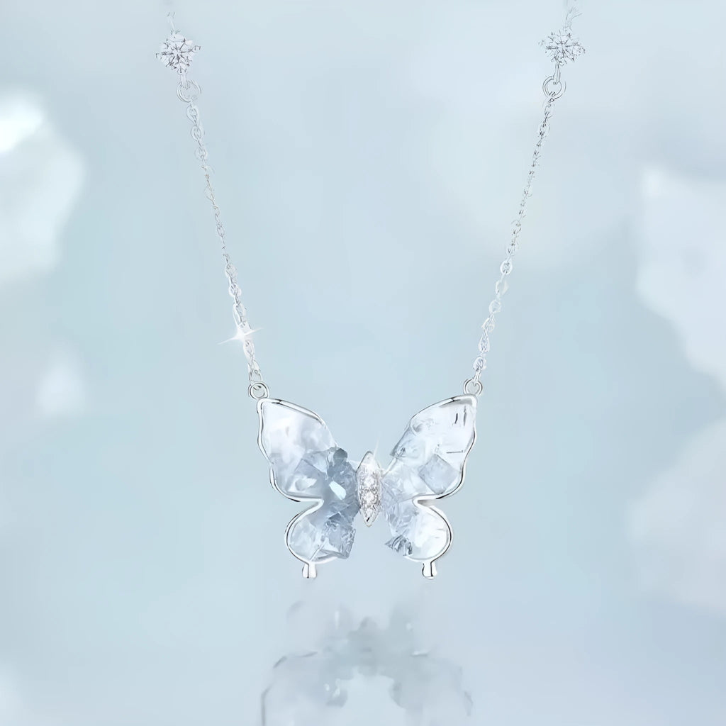 Close-up of a silver butterfly pendant necklace on an adjustable O-ring chain, showing detailed ice rain design.