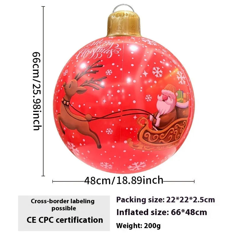 Large red and white inflatable Christmas ball with flashing lights in a garden setting.