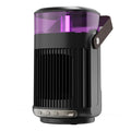 Black compact portable ceramic heater with humidifier unit on a table.