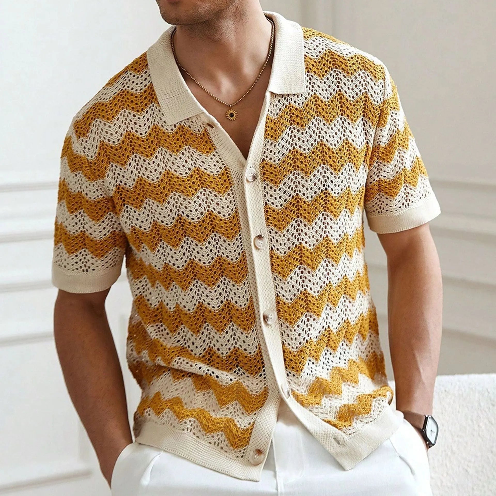 Short-sleeved yellow corrugated sweater with a hollow jacquard texture on a hanger.