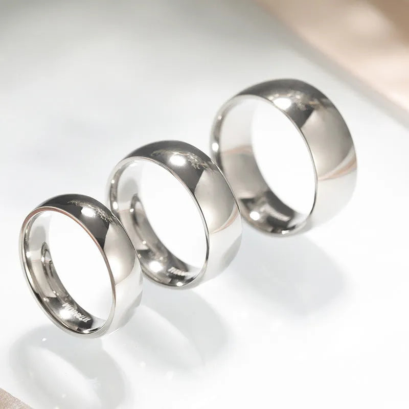 Silver titanium steel minimalist ring shown in various widths on a plain background.