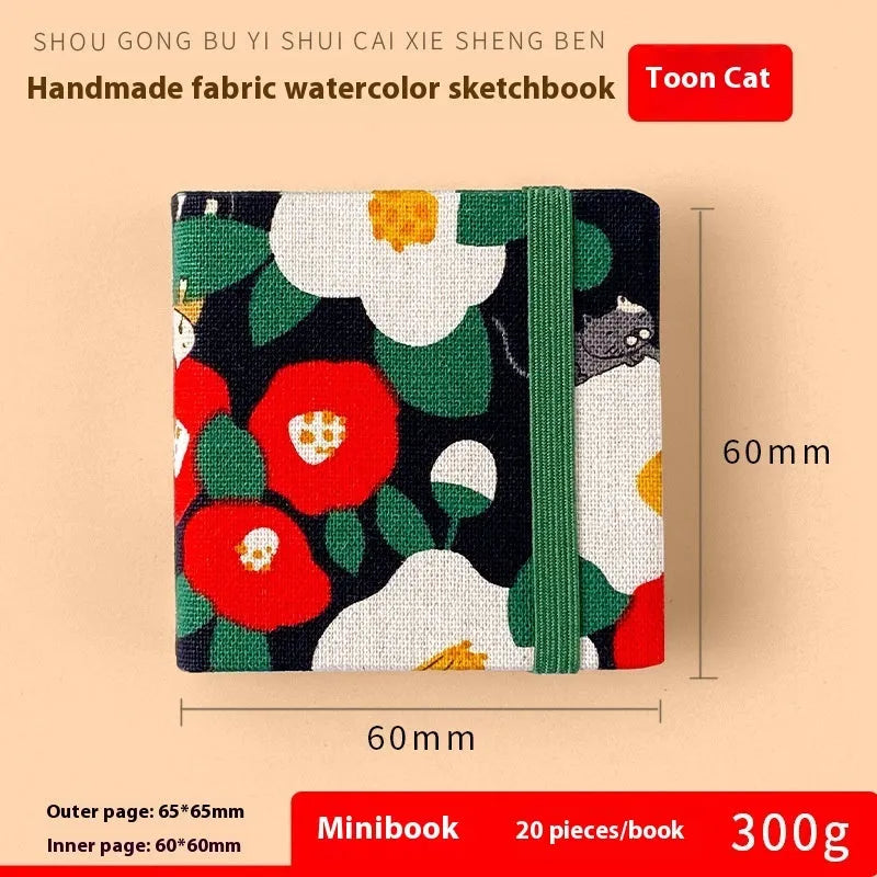 Feiluniao handmade fabric watercolour notebook in 185mm portable size, showing artistic cover design.