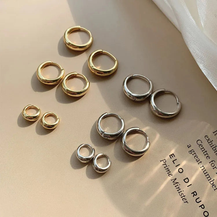 Women's minimalist water drop earrings in gold or silver with geometric round shape