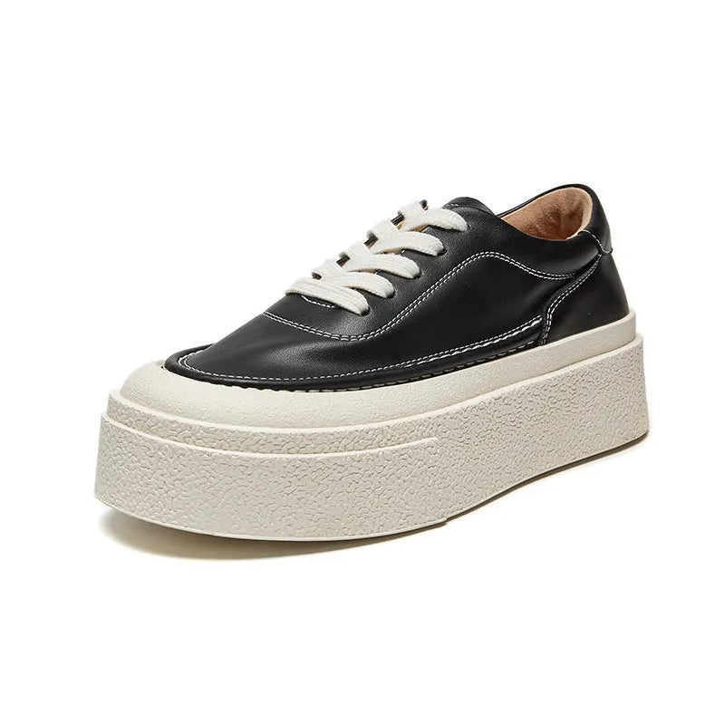 Women's black platform sports board shoes made from embossed cowhide leather with a rubber sole.