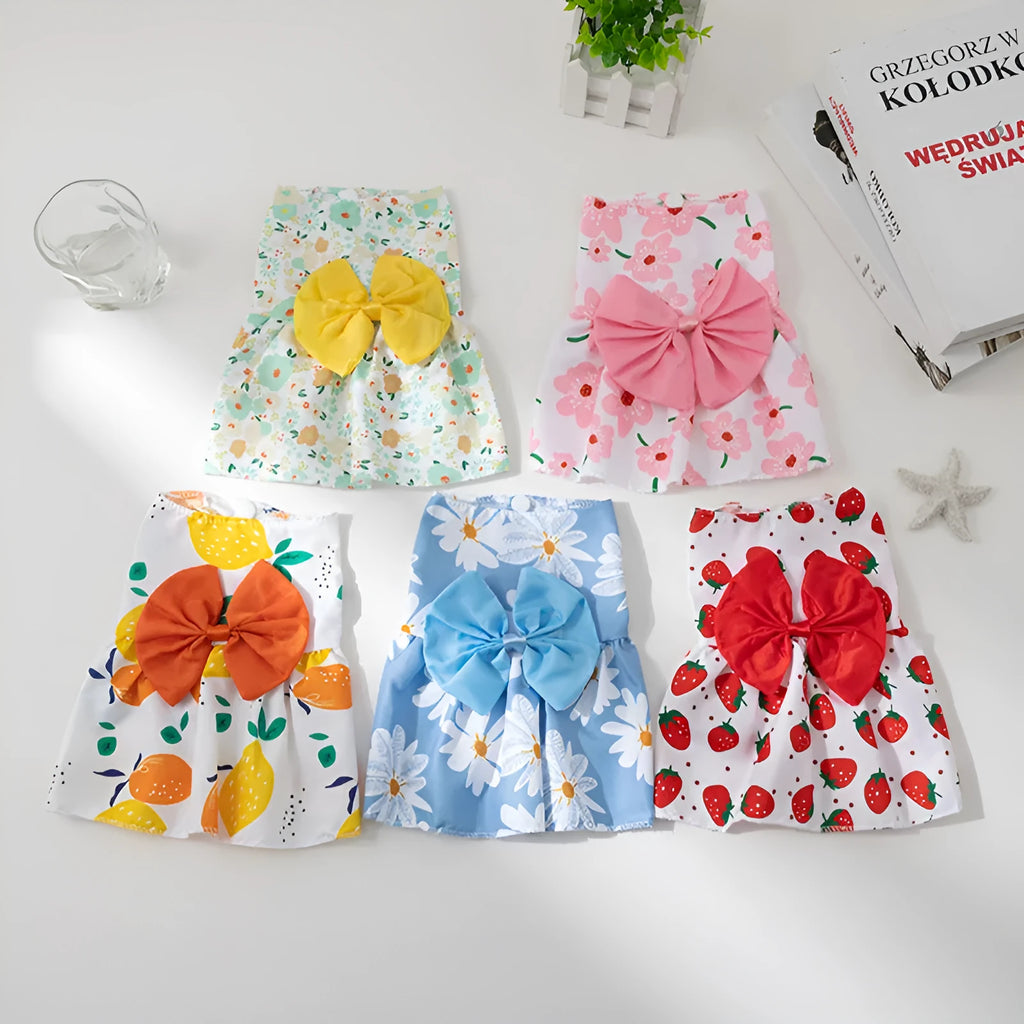 Orange floral butterfly pet dress with a bow on a dog, showing thin summer clothing.