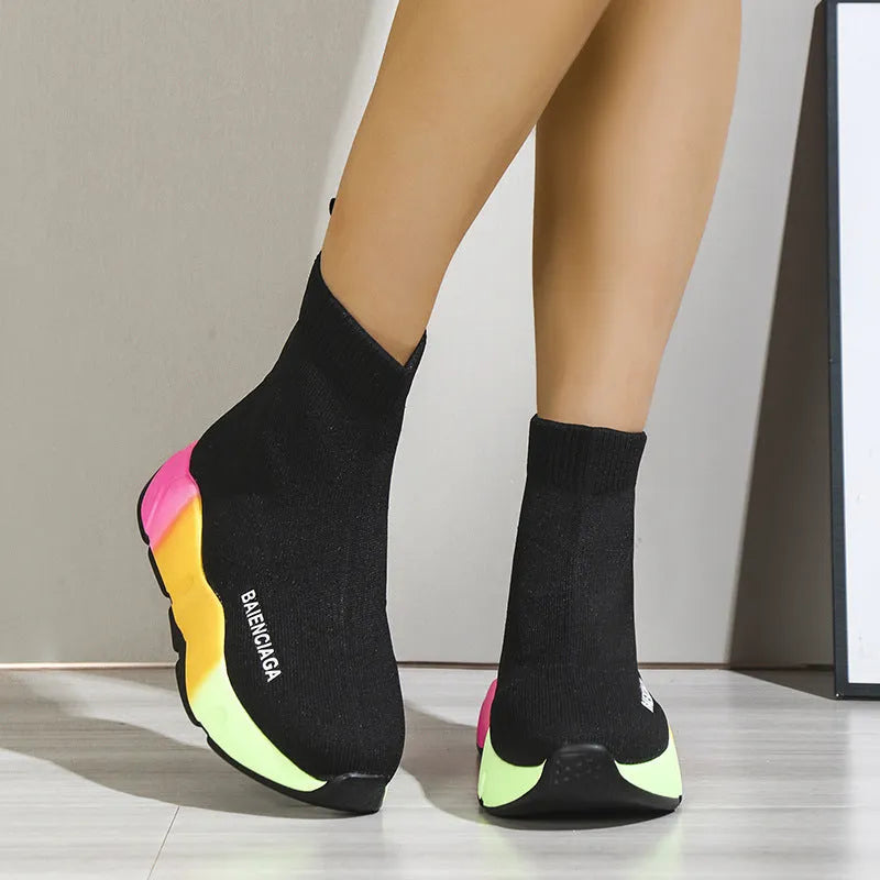 Women's black platform sock boots with cloth upper, rubber sole, round toe, thick heel, and low tube design on a neutral background