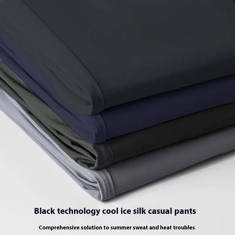 Man wearing black ice silk straight leg loose fit casual trousers with an elastic waistband
