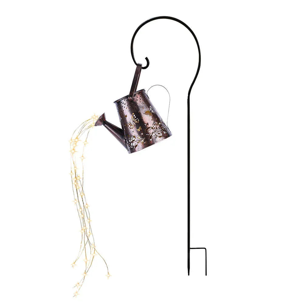 Tapered iron solar garden lantern with butterfly pattern emitting warm white light.