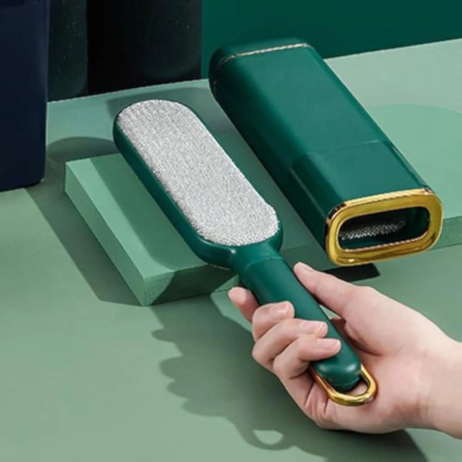 Double-sided reusable pet hair remover brush with storage box in blue, green or white.