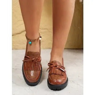Brown women's flat loafers with a decorative bow and elastic slingback.