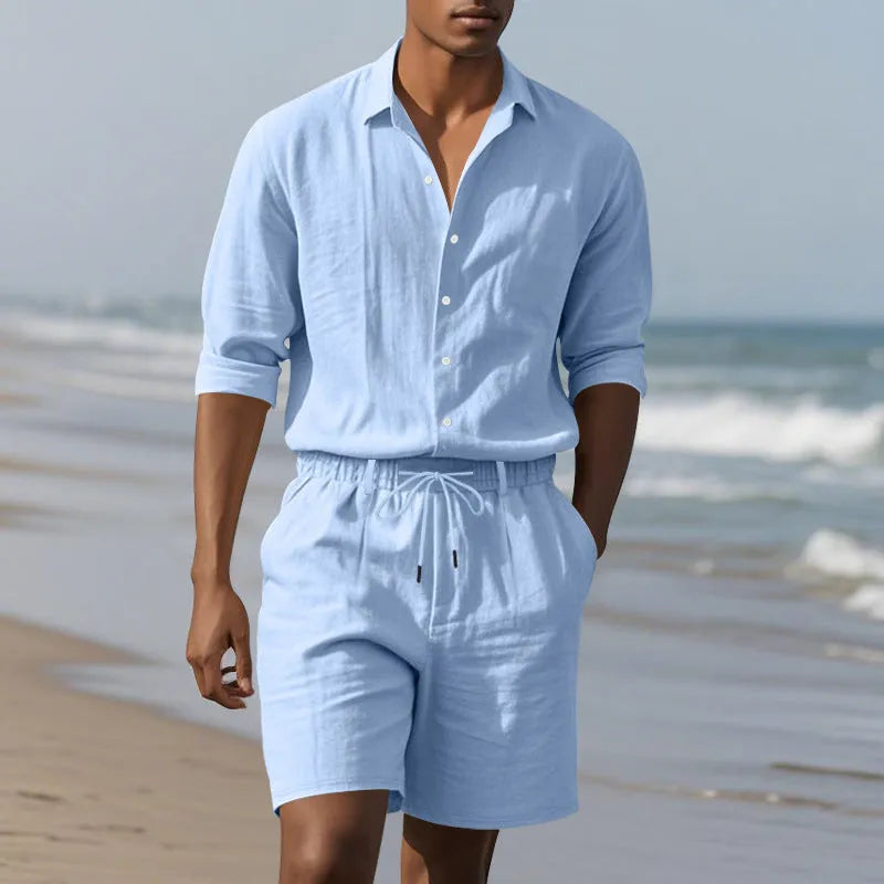 Linen long sleeve shirt and matching shorts beach set in light blue, laid flat.