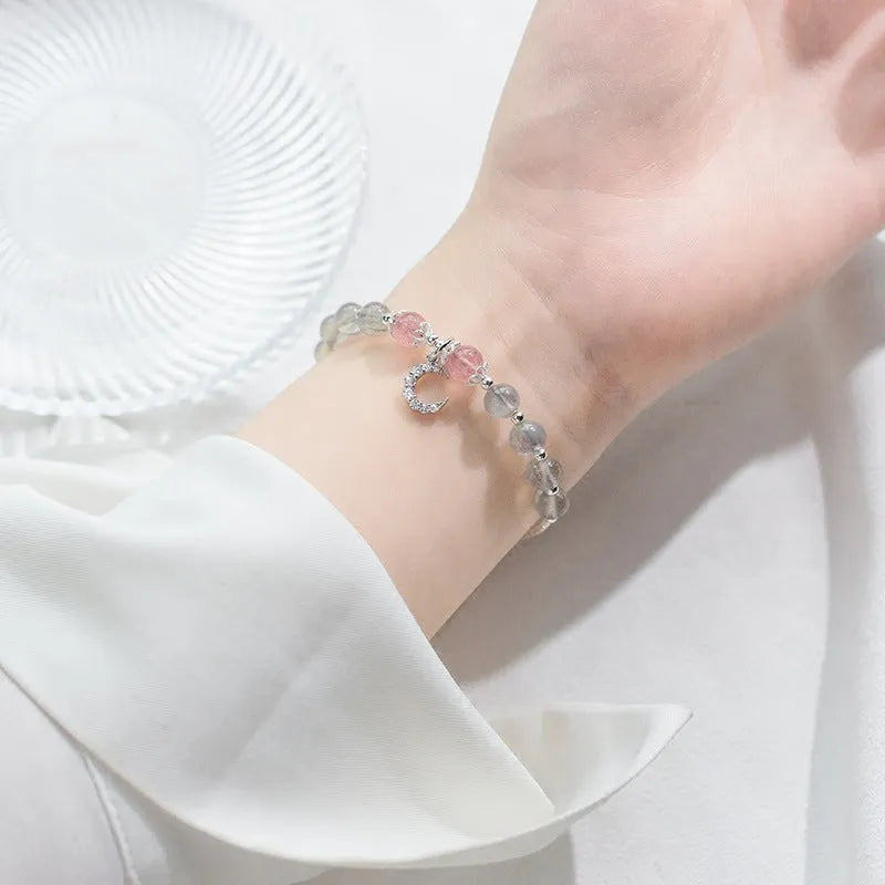 Natural moonstone bracelet with extension chain showing crescent moon and crystal accents