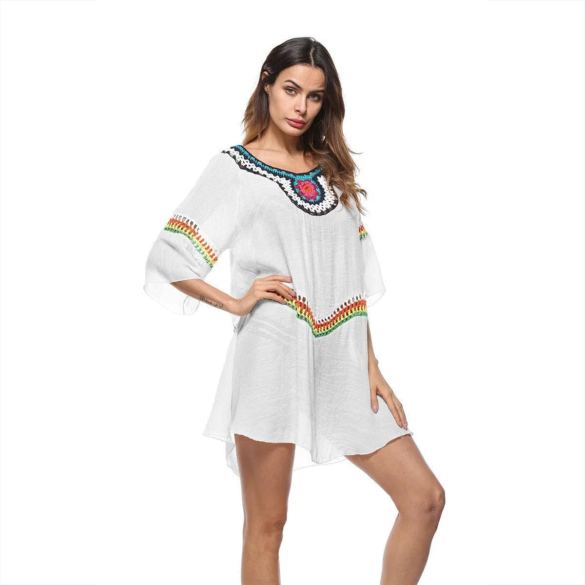 Women's crocheted white beach cover-up top for sun protection during swimming.