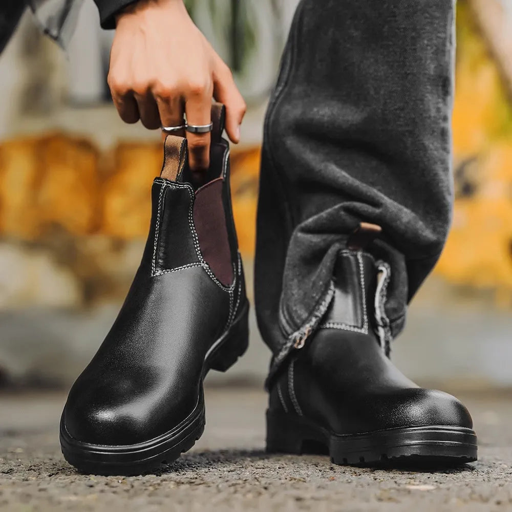 Vintage frosted brown PU leather Chelsea boots for men and women on a wooden surface.