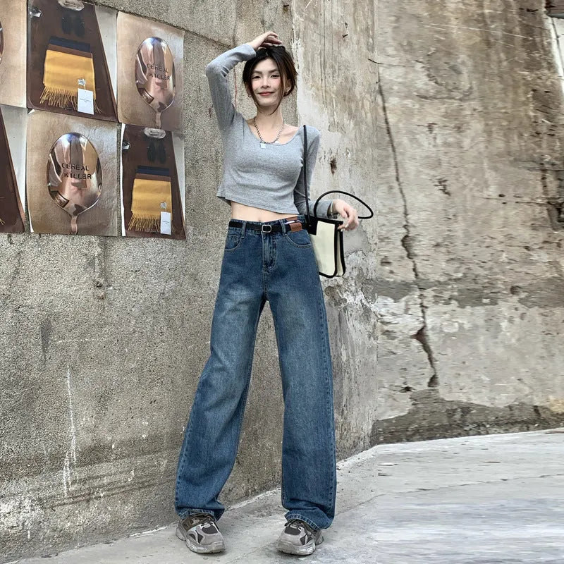 Women's retro blue high-waist straight-leg jeans on a neutral background.
