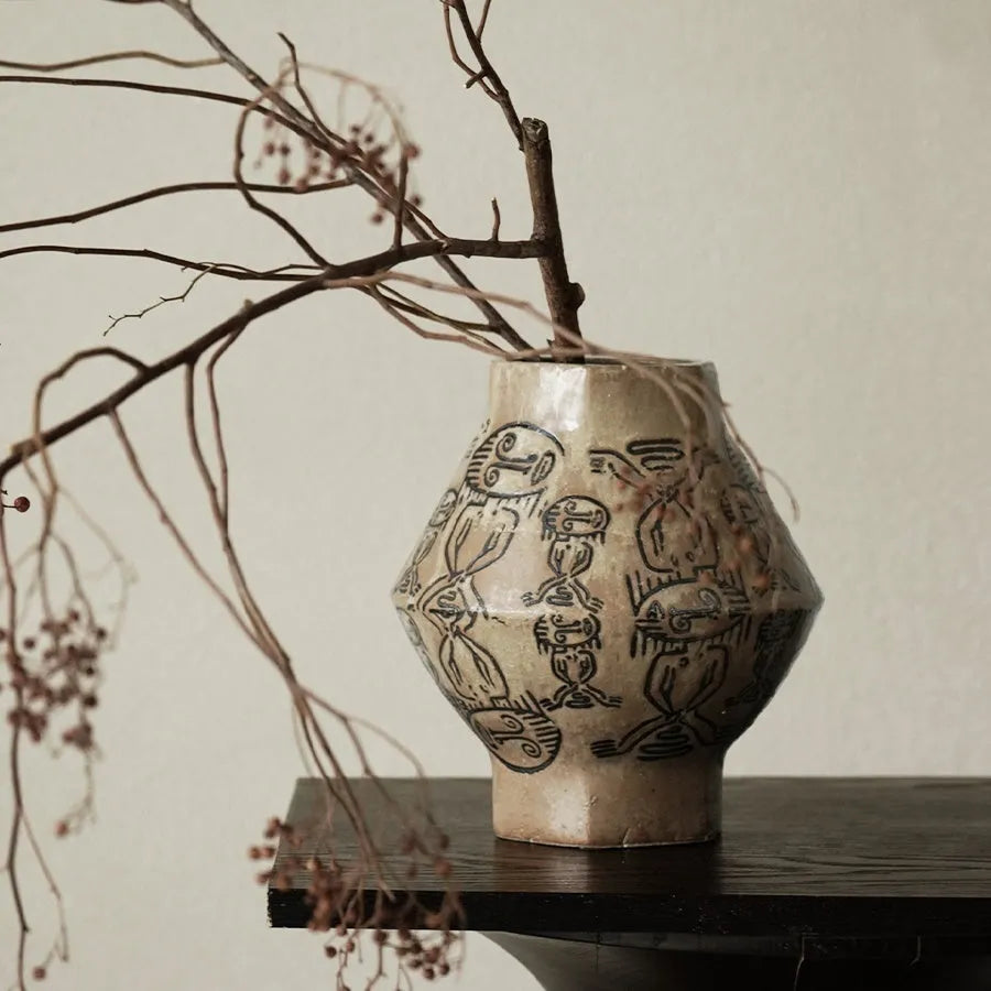 Hand-painted ceramic vase with vintage carved religious patterns in cylindrical shape